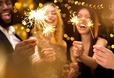 Adults happily holding sparklers