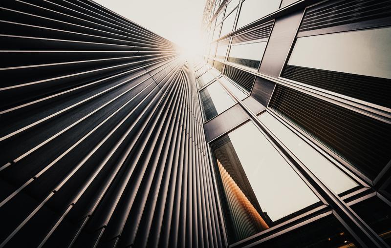 looking up at modern office building facade