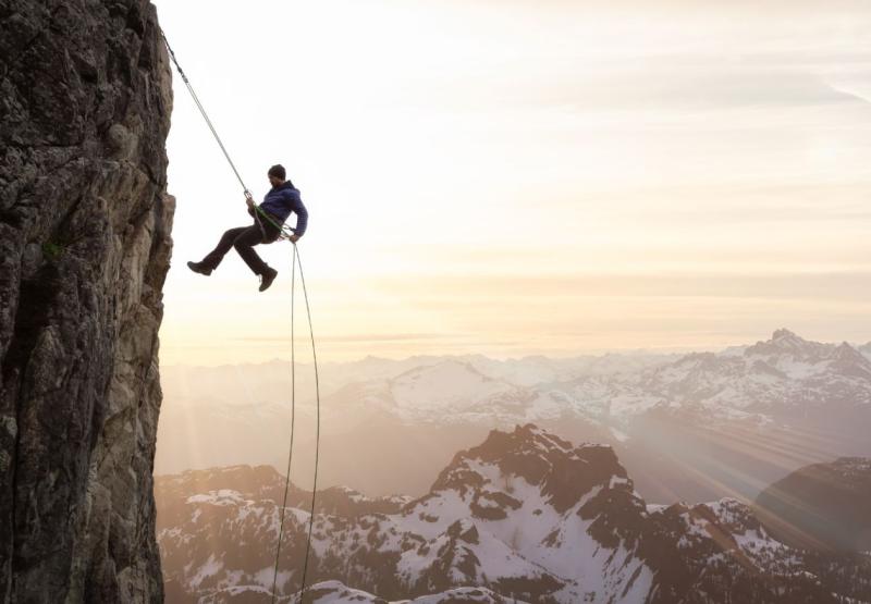 Man repelling from a mountain