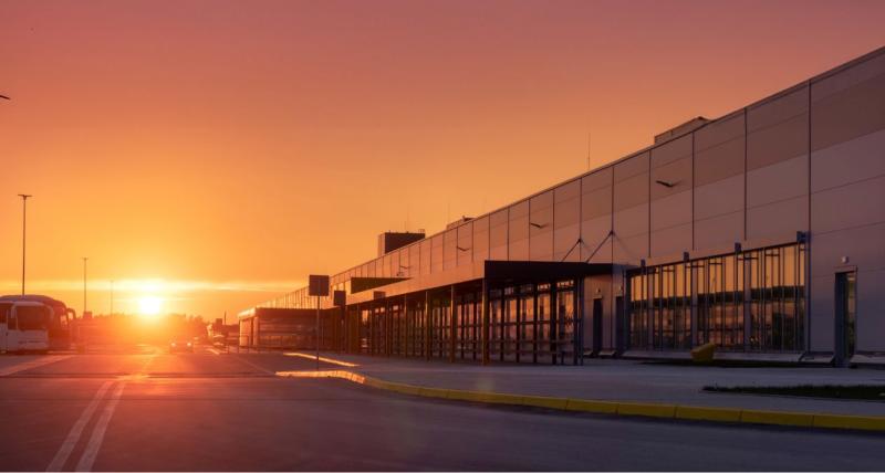 Industrial building along a road at sunset