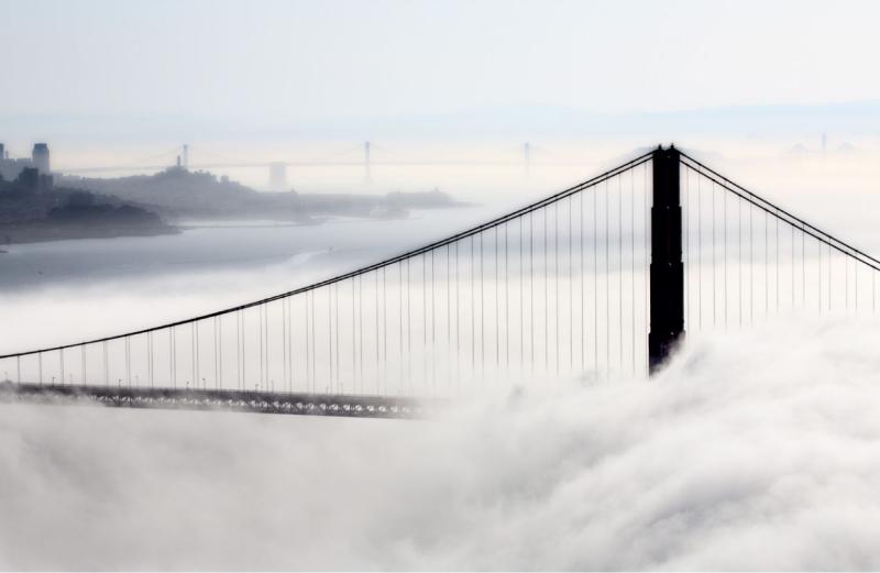 Suspension bridge covered by fog